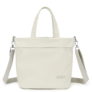 Detail of ivory nylon tote with Colorful Fox brand label and detachable shoulder strap