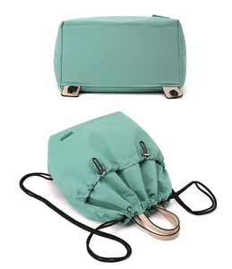 Detail of mint green nylon drawstring backpack with durable reinforced base and smooth stitching