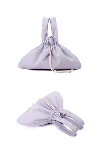 Detail of lavender nylon handbag featuring soft drawstring closure and premium texture