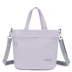 Detail of light purple nylon tote bag with detachable shoulder strap and dual handles