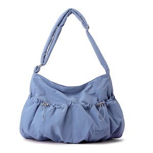 Close-up of fog blue nylon bag with pleated cloud design and dual drawstring pockets