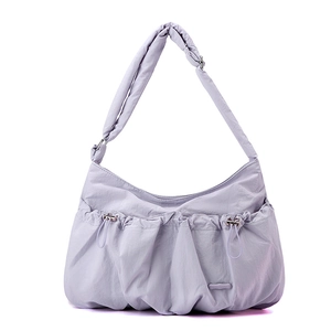 Detail of lavender nylon crossbody bag showing pleated drawstring and metallic buckle