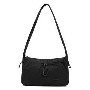 Close-up of black nylon cloud bag showing pleated texture and drawstring detail