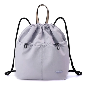 Detail of lavender drawstring backpack showing the nylon texture and Colorful Fox logo
