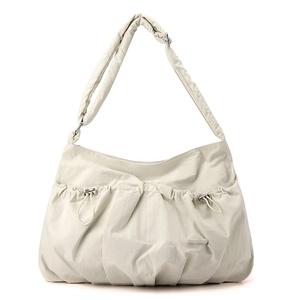 Detail of cream nylon crossbody bag featuring ruched drawstring texture and logo patch