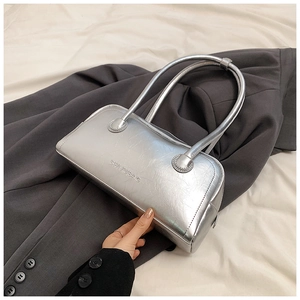 Macro shot of silver baguette bag with metallic texture and embossed SHIYUBAG logo