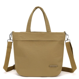 Detail of khaki nylon tote bag showing textured fabric and adjustable wide shoulder strap