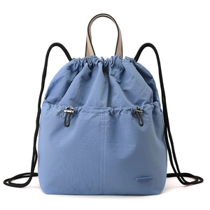 Detail showing sky blue nylon fabric texture and drawstring closure on the casual backpack