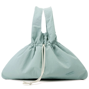 Detailed texture of mint green water-resistant nylon handbag with white drawstrings