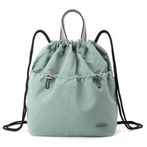Close-up of the drawstring closure and nylon fabric texture on the mint green backpack