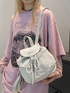 Minimalist beige nylon backpack with drawstring closure and buckle for daily casual use