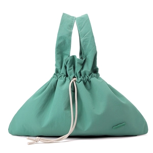 Detail showing mint green water-resistant nylon handbag with cream drawstring and brand label