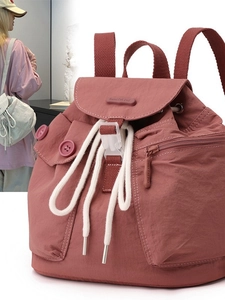 Waterproof nylon backpack in dusty rose featuring drawstring closure and flap cover