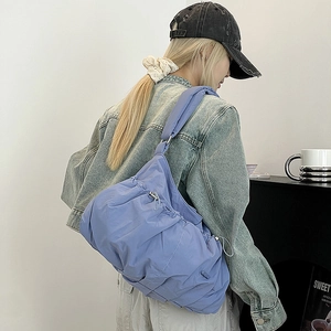 Light blue ruched nylon cloud bag featuring a drawstring design for casual styling