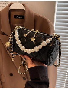 Chic black quilted cylinder crossbody bag with pearl chain and gold star charms