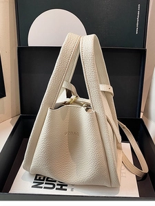 White litchi grain leather bucket bag with gold hardware and shoulder strap