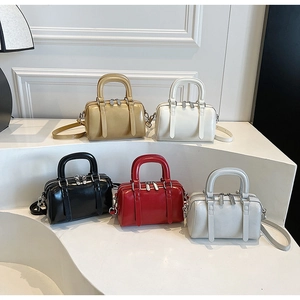 Detailed close-up of colorful Boston style mini handbags with glossy texture and silver hardware