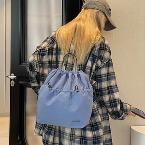 Close-up of light blue drawstring backpack made of lightweight waterproof nylon fabric