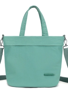 Lightweight mint green nylon tote bag with drawstring design and adjustable shoulder strap