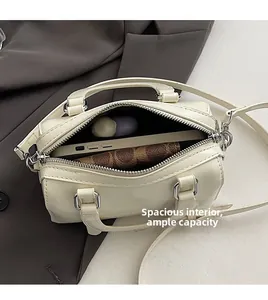Internal view showing large capacity of the beige Boston bag for phone and wallet