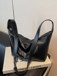 Classic black dumpling tote bag with V-shaped stitching and adjustable shoulder strap