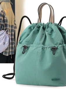 Mint green nylon drawstring backpack with cream handles and large capacity storage