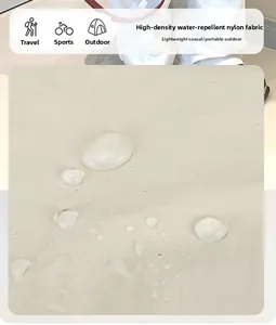 Detail of high-density waterproof nylon fabric with water droplets on light beige surface