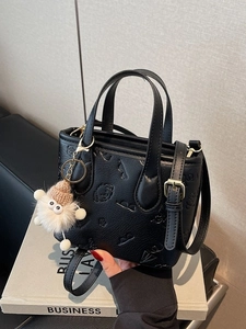 Contrast color bucket bag with embossed dog pattern and creative white pompom charm