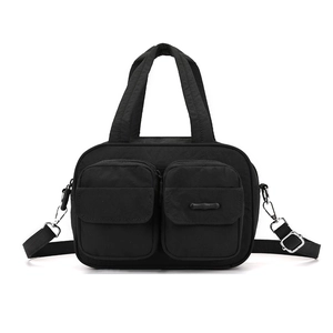 Detail of black nylon utility bag featuring dual front zip pockets and durable top handles