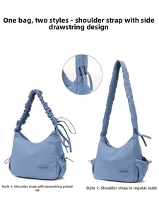Detail of adjustable drawstring shoulder strap on sky blue nylon dumpling bag