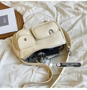 Internal capacity of cream PU leather handbag showing storage for makeup and accessories