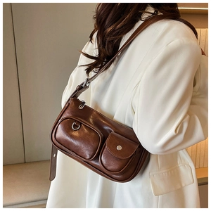 Close-up of brown PU leather shoulder bag with double pockets and silver hardware detail