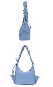 Detail of light blue nylon dumpling bag with pleated scrunchie strap and drawstring accents