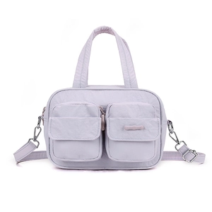 Detail view of lavender multi-pocket crossbody bag in water-resistant nylon material
