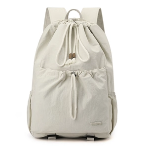 Detail view of large nylon drawstring backpack with front pocket and side compartments