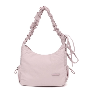 Detail of light pink nylon shoulder bag with scrunchie strap and side drawstring design