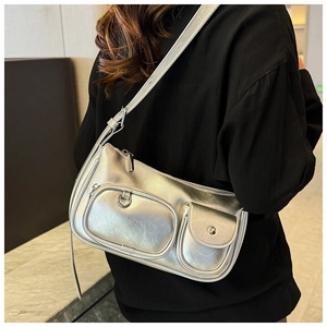 Detailed view of silver metallic Y2K shoulder bag featuring functional dual front pockets