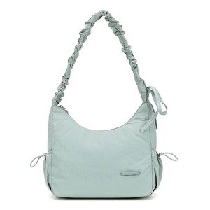 Detail of light green nylon shoulder bag featuring ruched strap and drawstring accents