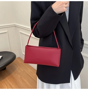 Fashionable dark red rectangular shoulder bag styled with black blazer and white skirt