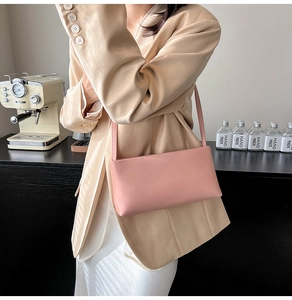 Pink rectangular minimalist shoulder bag styled with a beige blazer and white silk dress