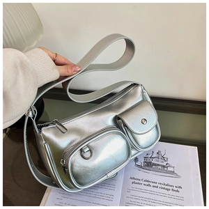 Detail of silver metallic crossbody bag with multiple cargo pockets and long strap
