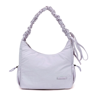 Detailed view of the lavender nylon crossbody bag with drawstring sides and ruched strap
