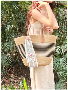 Straw beach tote bag with black stripes and elegant white lace ribbon decoration