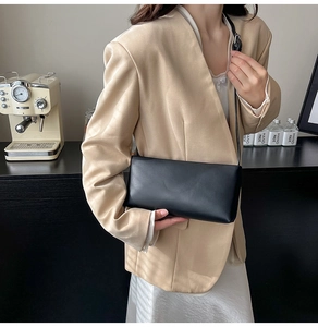 Chic black rectangular underarm bag styled with a beige blazer and silk dress