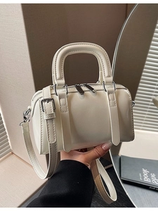 Mini cream Boston handbag in glossy faux leather with silver hardware and shoulder strap
