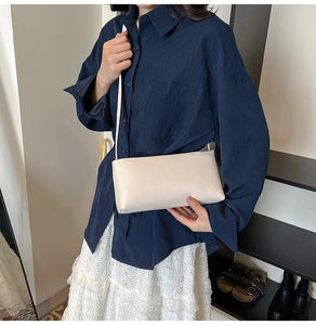 Minimalist white rectangular shoulder bag in PU leather shown with a stylish model outfit