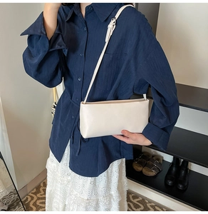 Chic cream white rectangle crossbody bag shown on shoulder for size and style reference