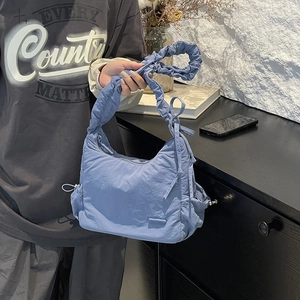 Detailed view of Morandi blue nylon cloud bag featuring pleated straps and soft texture