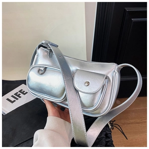 Detail of silver metallic shoulder bag with dual front pockets and glossy finish