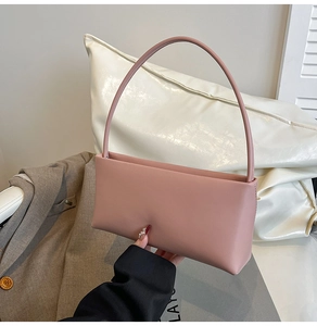 Detail of dusty pink rectangular handbag with matte PU leather finish and slim strap